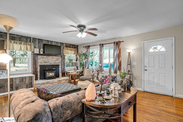 living area featuring baseboards, wood finished floors, and a ceiling fan