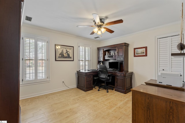 office area with a wealth of natural light, light wood-type flooring, and crown molding