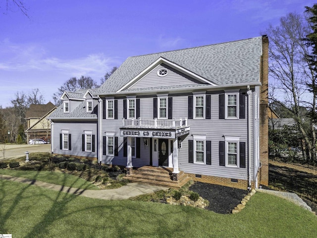 view of front of property with crawl space, a front yard, roof with shingles, and a chimney