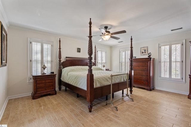 bedroom with visible vents, baseboards, ornamental molding, and light wood finished floors