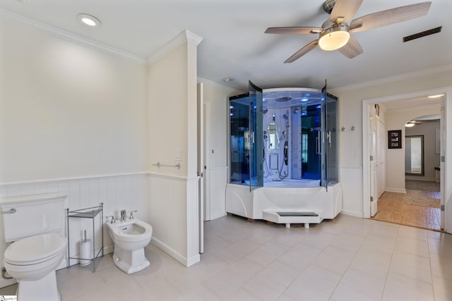 full bath featuring visible vents, toilet, a bidet, and a wainscoted wall