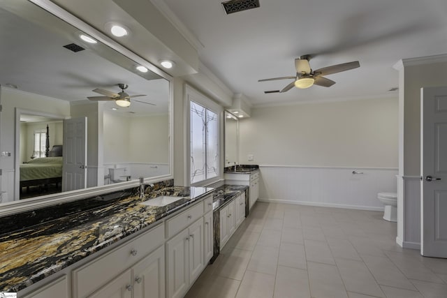 bathroom with visible vents, a healthy amount of sunlight, ornamental molding, and ensuite bathroom