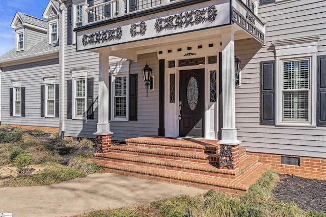 entrance to property featuring crawl space and a shingled roof