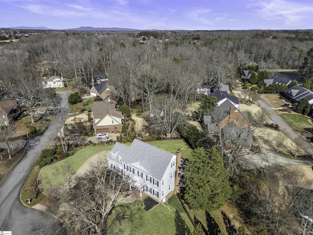 birds eye view of property featuring a view of trees