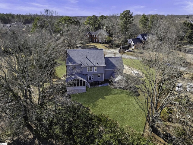 bird's eye view with a wooded view