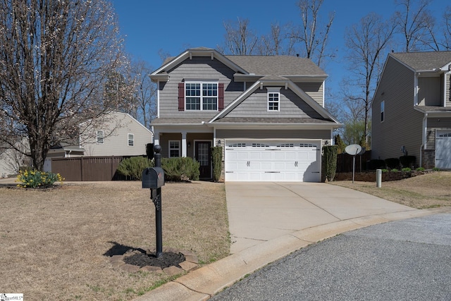 craftsman inspired home featuring concrete driveway, fence, and a garage