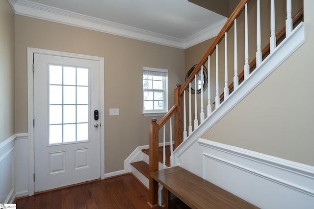 doorway to outside featuring dark wood-style floors, baseboards, ornamental molding, and stairway