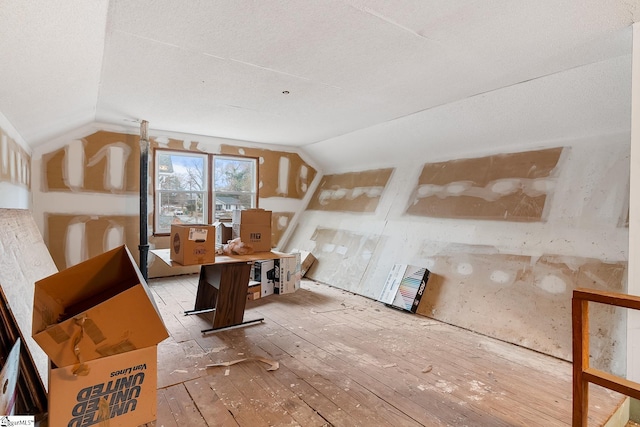 interior space with lofted ceiling and hardwood / wood-style floors