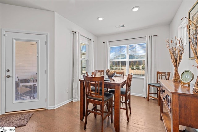 dining room with visible vents, recessed lighting, baseboards, and wood finished floors