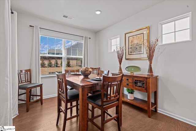 dining space with recessed lighting, visible vents, baseboards, and wood finished floors