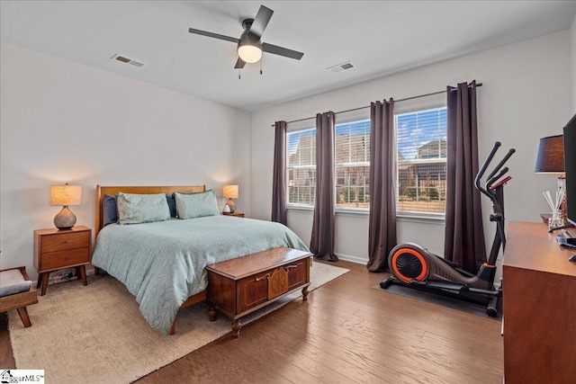 bedroom featuring ceiling fan, visible vents, and hardwood / wood-style floors