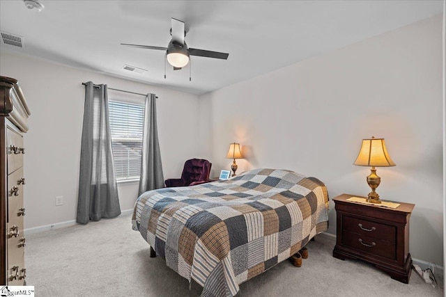 carpeted bedroom featuring visible vents, baseboards, and ceiling fan