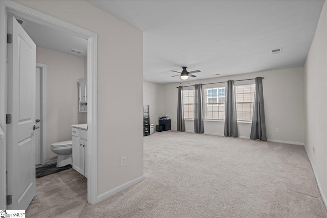 living room featuring visible vents, baseboards, and light colored carpet