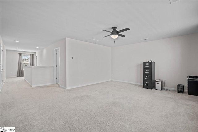 empty room featuring baseboards, light carpet, and a ceiling fan