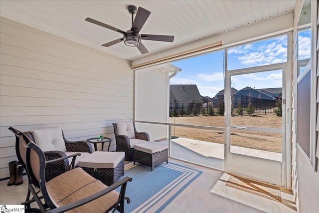 sunroom with wooden ceiling and a ceiling fan