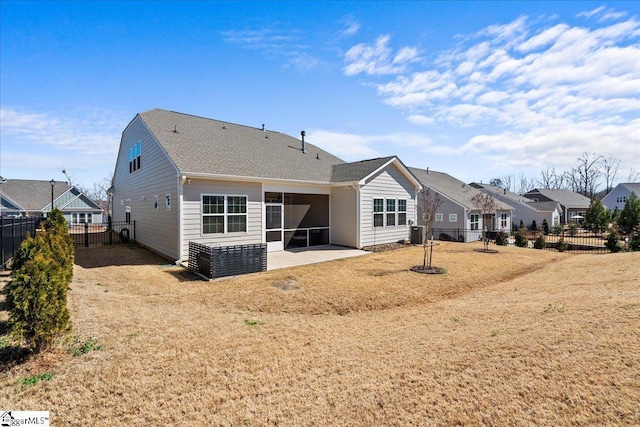 back of house with a patio, a yard, and a fenced backyard