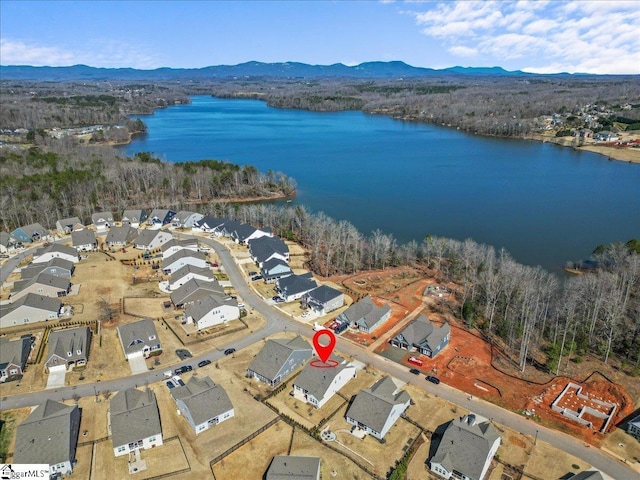 drone / aerial view featuring a residential view and a water and mountain view