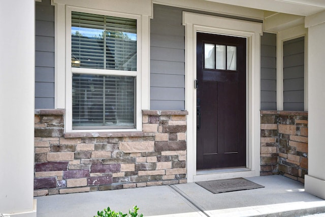 entrance to property featuring stone siding