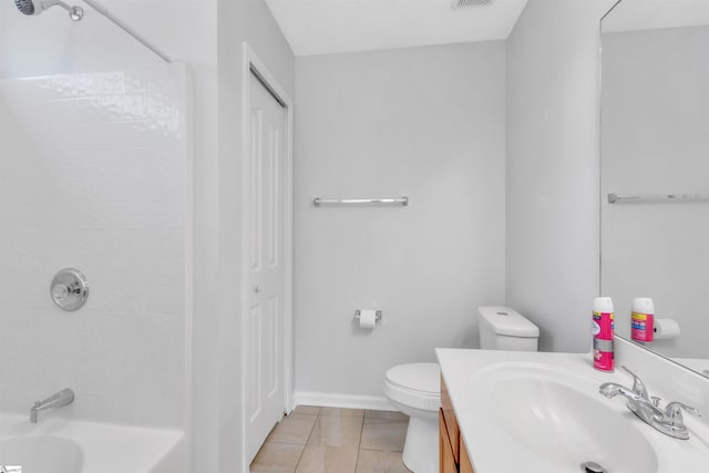 bathroom featuring tile patterned floors, a closet, toilet, and vanity