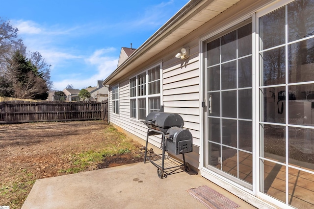 view of patio / terrace with a grill and fence