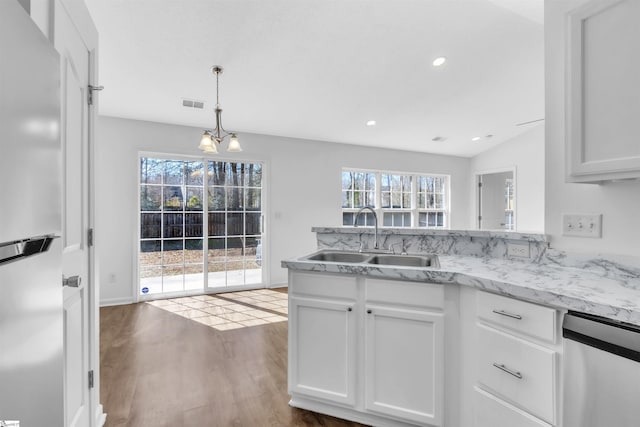 kitchen featuring a sink, stainless steel appliances, visible vents, and white cabinetry