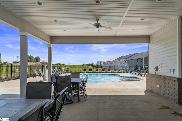 community pool with a patio, a ceiling fan, and fence