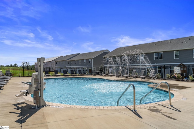 pool featuring a patio area, a residential view, and fence