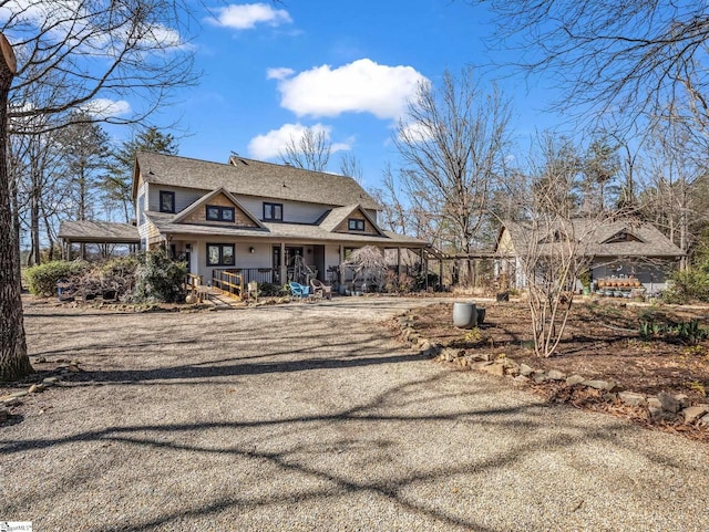 rear view of house featuring an attached carport and driveway