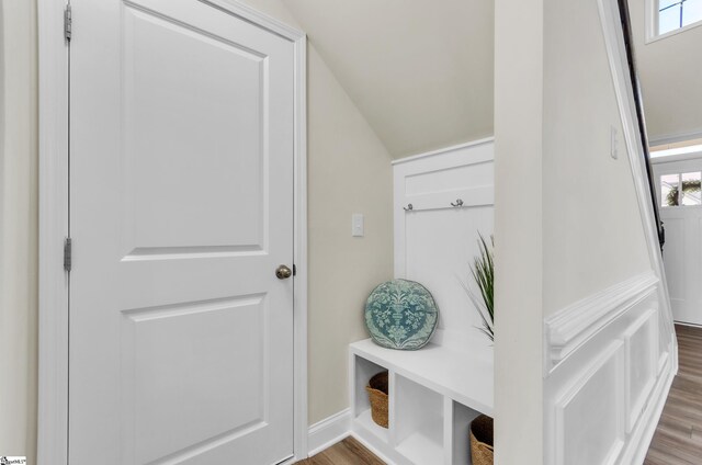 mudroom with baseboards, lofted ceiling, and wood finished floors