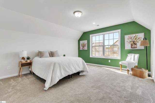 bedroom featuring visible vents, lofted ceiling, baseboards, and carpet flooring