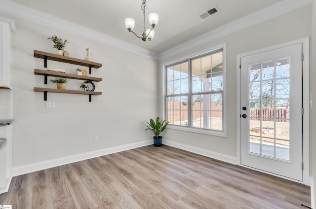 unfurnished dining area with crown molding, plenty of natural light, light wood-style floors, and visible vents