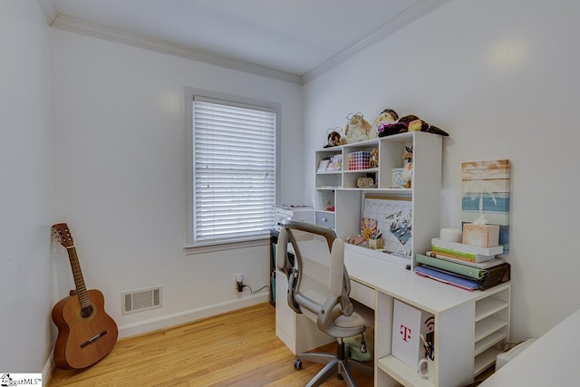 office area with light wood finished floors, visible vents, crown molding, and baseboards