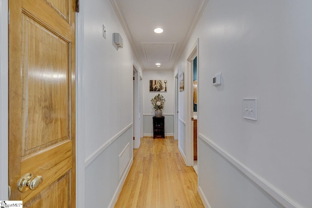 hallway with visible vents, light wood-style flooring, ornamental molding, recessed lighting, and attic access