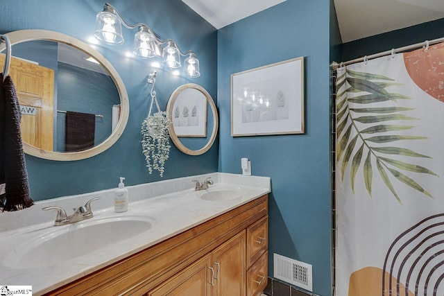 full bathroom featuring a sink, visible vents, and double vanity