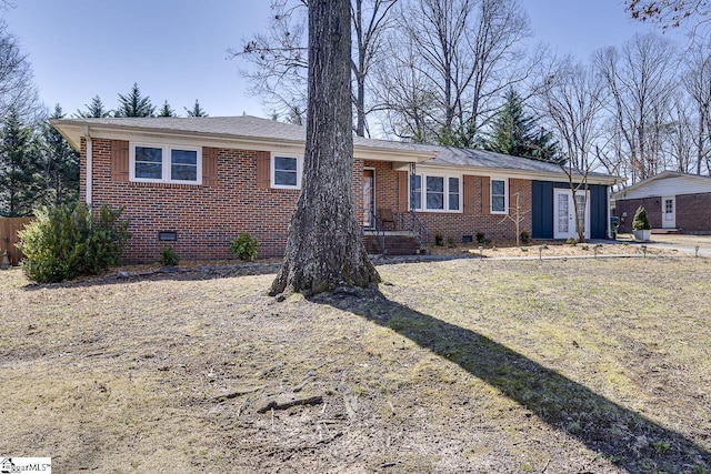 ranch-style home with fence, brick siding, and crawl space