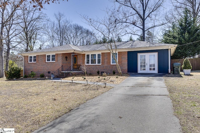 single story home featuring fence, brick siding, and crawl space