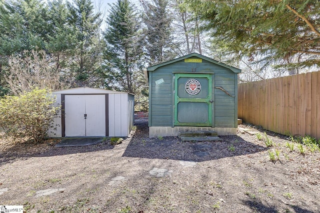 view of shed with fence