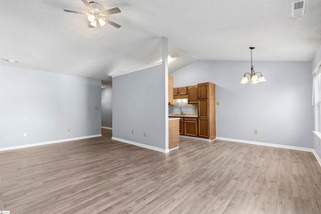 unfurnished living room with a sink, visible vents, and light wood-type flooring