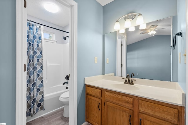 bathroom featuring vanity, shower / bath combo, ceiling fan, a textured ceiling, and toilet