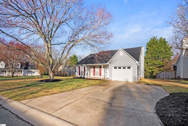 view of front facade featuring a front yard, concrete driveway, fence, and a garage