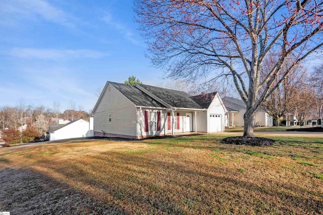 view of front of property featuring an attached garage and a front lawn