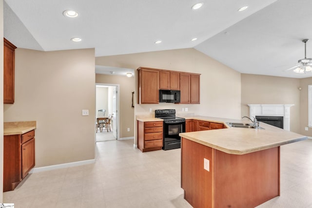 kitchen featuring black appliances, a ceiling fan, a sink, a peninsula, and light countertops