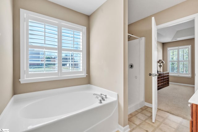 full bath with a shower stall, a bath, baseboards, and tile patterned floors