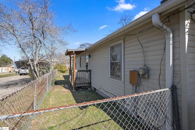 view of side of home featuring fence