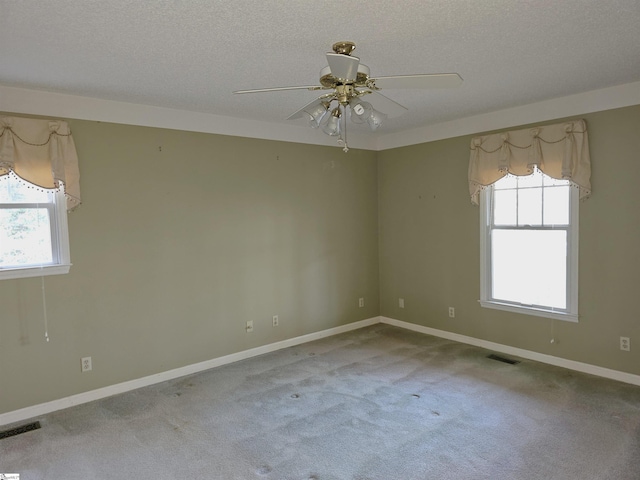 empty room with visible vents, carpet floors, and a healthy amount of sunlight