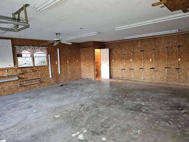 garage featuring wood walls