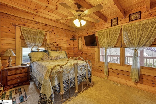 bedroom with wooden walls, visible vents, wood ceiling, beamed ceiling, and carpet flooring