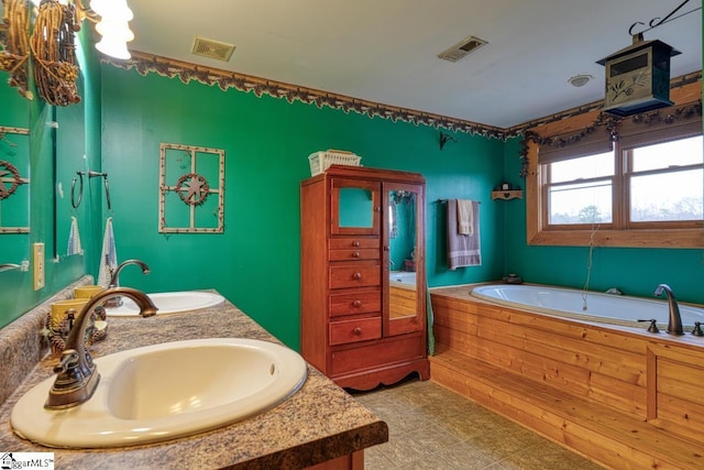 bathroom featuring double vanity, a bath, visible vents, and a sink