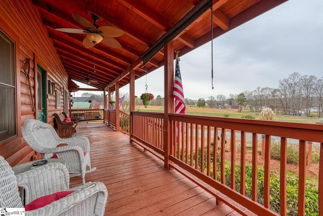 wooden deck featuring ceiling fan