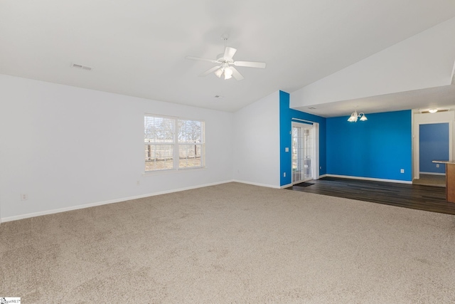 unfurnished living room with visible vents, baseboards, lofted ceiling, and carpet floors